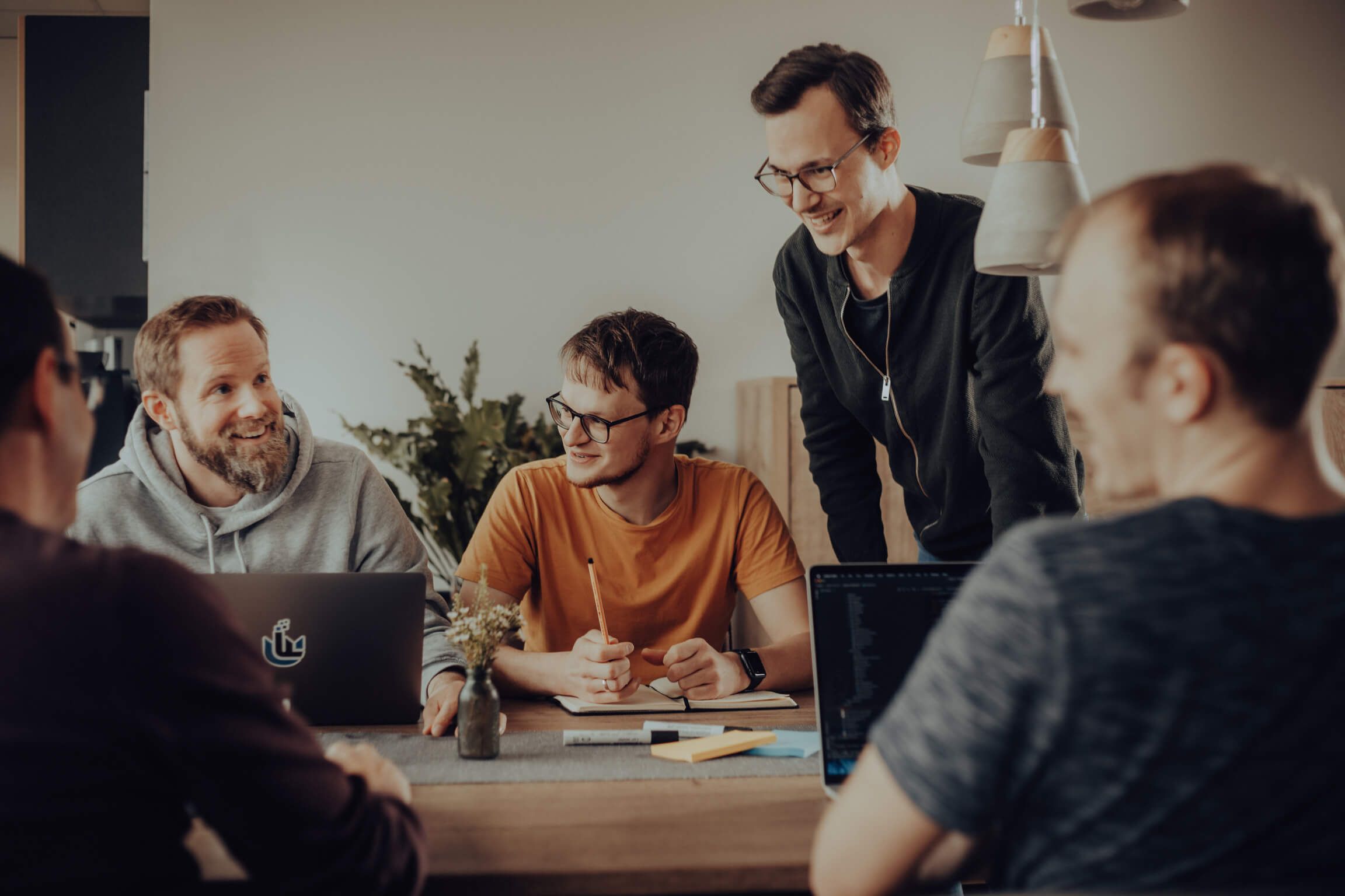 A team of software developers in conversation at a table
